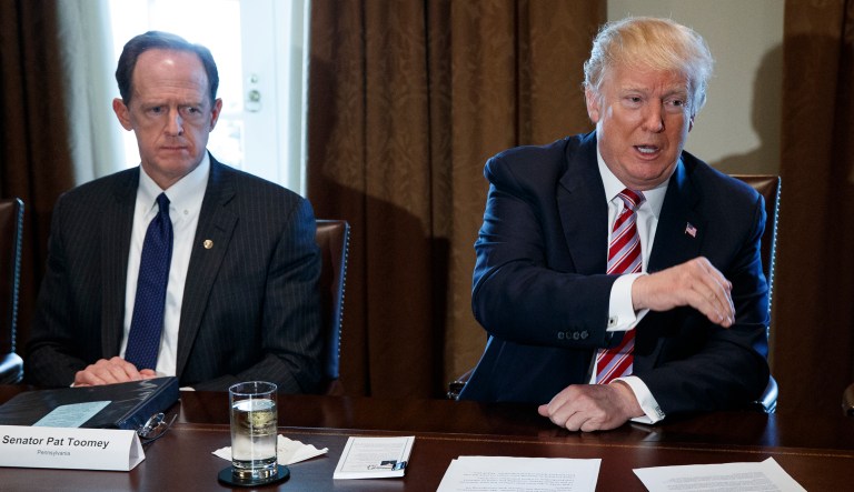 Sen. Pat Toomey, R-Pa., left, and Rep. Kevin Brady, R-Texas, right, listen as President Donald Trump speaks during a meeting with lawmakers about trade policy in the Cabinet Room of the White House, Tuesday, Feb. 13, 2018, in Washington.