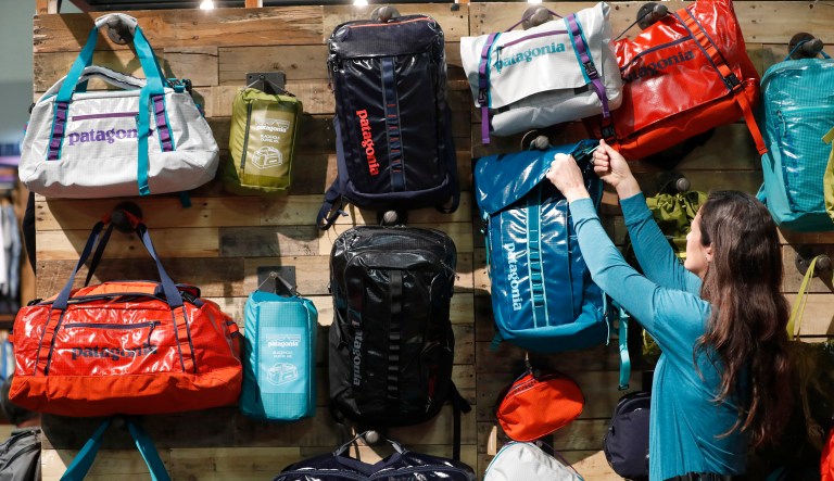 An attendee grabs a Patagonia Inc. bag at the company's booth during the 2017 Outdoor Retailers Winter Market Show in Salt Lake City, Utah, U.S., on Wednesday, Jan. 11, 2017. The Bloomberg Consumer Comfort Index, a survey which measures attitudes about the economy, is scheduled to be released on January 12.