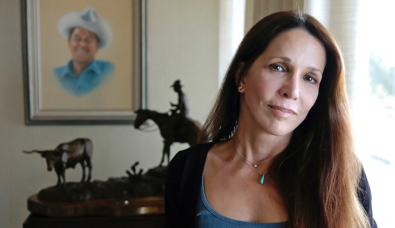 Patti Davis, daughter of late U.S. president Ronald Reagan and Nancy Reagan, poses near artwork given to the resident at the Ronald Reagan Presidential Library in Simi Valley, Calif. 
