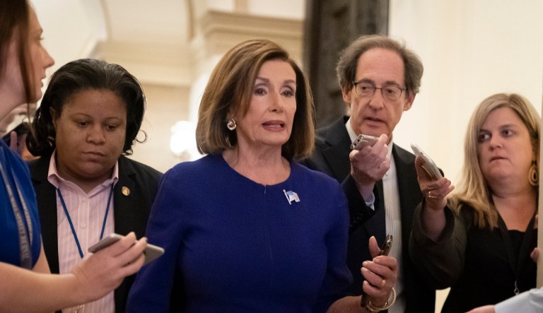 Speaker of the House Nancy Pelosi, D-Calif., is questioned by reporters as she departs the Capitol en route to a speaking event in Washington, Tuesday, Sept. 24, 2019. 