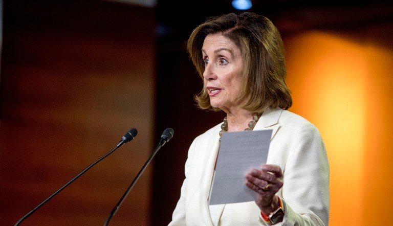 House Speaker Nancy Pelosi of Calif. reads from a paper titled "Know Your Rights" regarding ICE agents attempting to perform raids as she meets with reporters on Capitol Hill in Washington, Thursday, July 11, 2019.