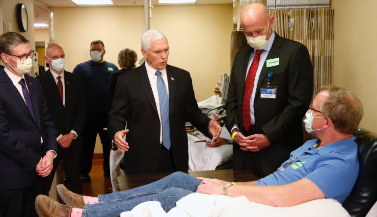 Vice President Mike Pence, center, visits a patient who survived the coronavirus and was going to give blood during a tour of the Mayo Clinic Tuesday, April 28, 2020, in Rochester, Minn. as he toured the facilities supporting COVID-19 research and treatment. 
