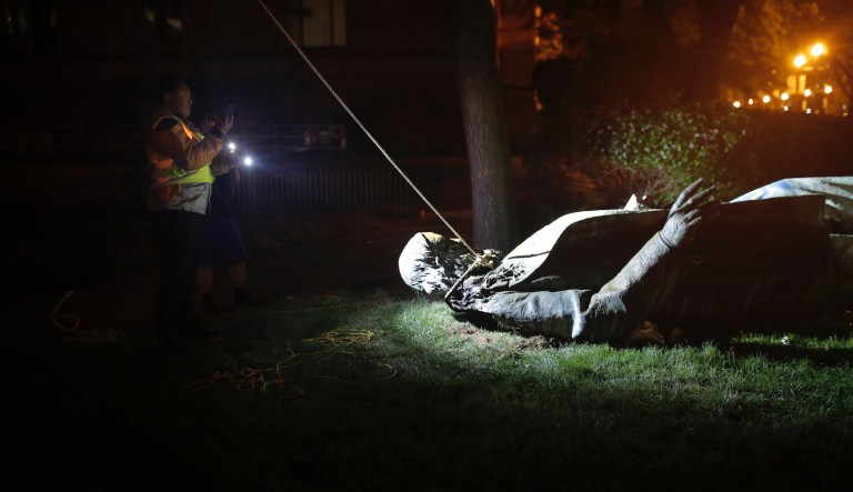 People film the only statue of a Confederate general, Albert Pike, in the nation's capital after it was toppled by protesters and set on fire in Washington early Saturday, June 20, 2020. It comes on Juneteenth, the day marking the end of slavery in the United States, amid continuing anti-racism demonstrations following the death of George Floyd in Minneapolis.
