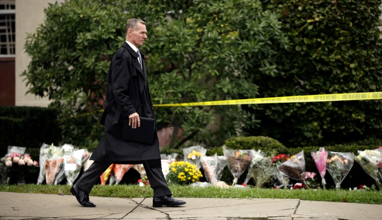 Federal Bureau of Investigation Pittsburgh special agent in charge, Bob Jones, walks near a makeshift memorial at the Tree of Life Synagogue in Pittsburgh, Sunday, Oct. 28, 2018.