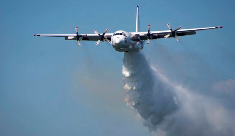 In this undated hand out photo from the Rural Fire Service, a C-130 Hercules plane called ÃgThorÃh drops water during a flight in Australia. Officials in Australia on Thursday, Jan. 23, 2020, searched for a water tanker plane feared to have crashed while fighting wildfires.