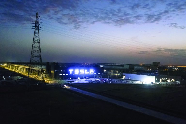 The Tesla Inc. Gigafactory stands illuminated at night in Shanghai, China.