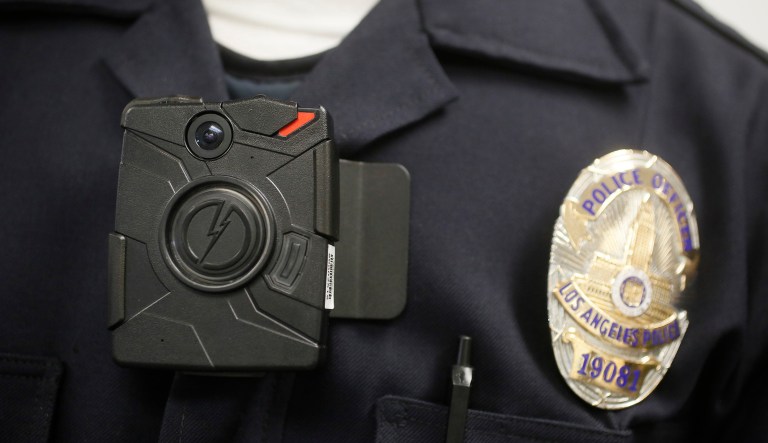 FILE - In this Jan. 15, 2014 file photo a Los Angeles Police officer wears an on-body camera during a demonstration in Los Angeles.