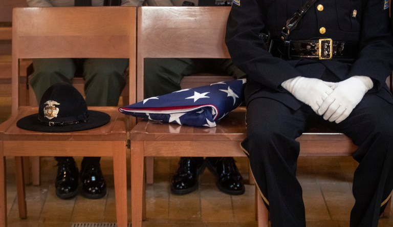 An Honor guard waits with an American flag during funeral mass of slain Los Angeles Police Department officer Juan Diaz at the Cathedral of Our Lady of the Angels in Los Angeles, Calif., on Monday, Aug. 12, 2019.
