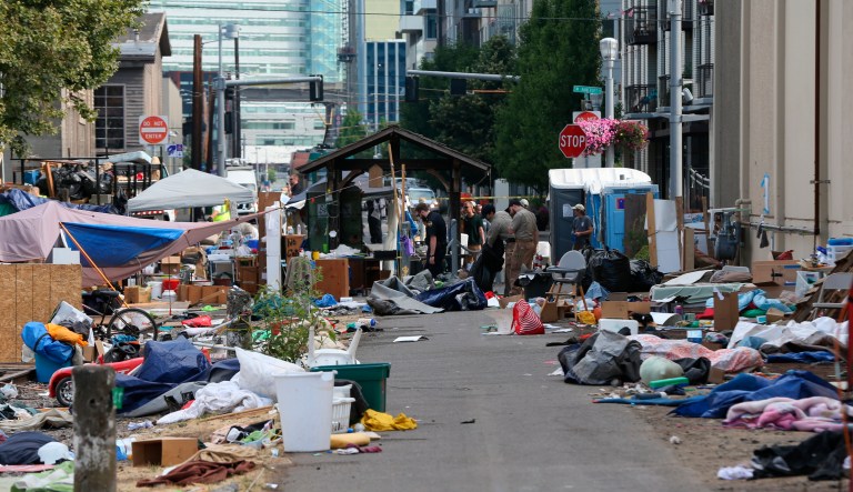 Authorities clear the protest encampment at the Southwest Portland offices of the Federal Immigration and Customs Enforcement agency on Wednesday, July 25, 2018, in Portland, Ore.
