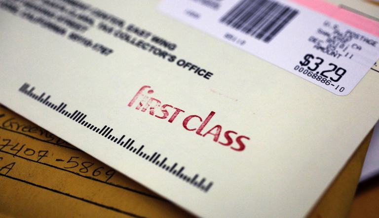 A first class envelope is shown at a U.S. Post Office in San Jose, Calif., Monday, Dec. 5, 2011.