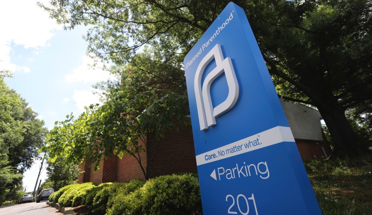 FILE - This May 15, 2019, file photo shows a sign in front of the Planned Parenthood offices in Richmond, Va. At least a dozen lawsuits have been filed over the last two years challenging what abortion-rights groups call targeted restrictions on abortion providers. Planned Parenthood is challenging physician-only laws in Virginia, Maine, Wisconsin, Idaho and Arizona.