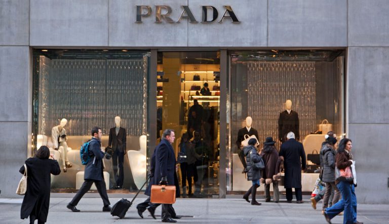 New York City, USA - Dec. 6, 2012: The Prada store on Fifth Avenue in Midtown Manhattan. Prada is a well known designer of men's and women's clothing and accessories. Many people can be seen on the sidewalk.