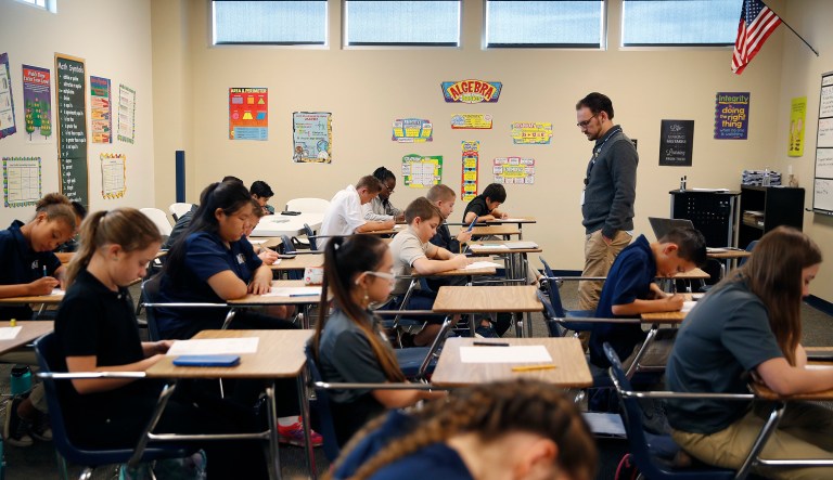 In this Nov. 16, 2017, photo, students take a quiz in Michael Briggs' seventh grade algebra class at Lake Mead Christian Academy in Henderson, Nev. Standardized tests are a given in public schools, and they're mandatory for Nevada private schools participating in the state's budding school-choice program. Schools in Nevada's voucher-like program for low-income families are required to begin submitting test results next year and Nevada is trying figuring out what to do with that information.