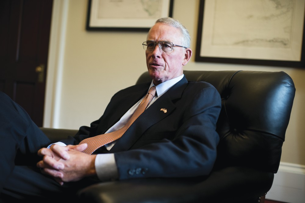 Francis Rooney, a politician, sits in an office chair.