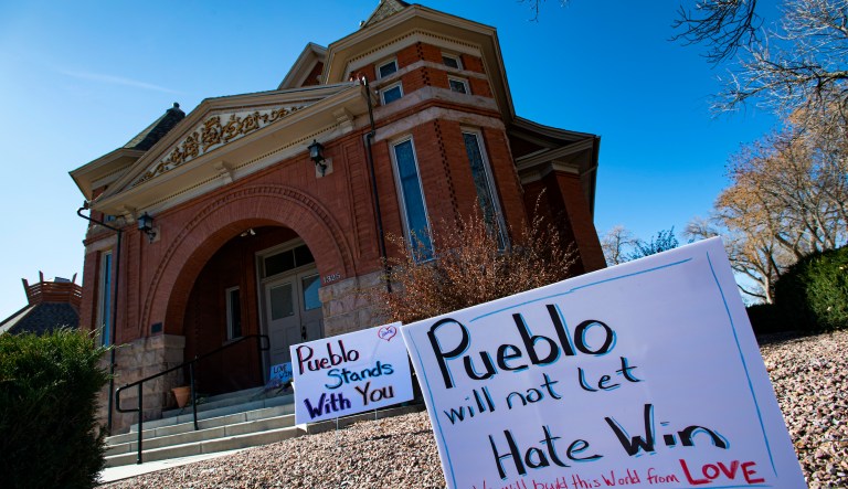 In this Nov. 5, 2019, file photo, signs, flowers and candles expressing love for the Jewish community stand outside the Temple Emanuel in Pueblo, Colo. Richard Holzer, 28, was sentenced to nearly 20 years in prison on Friday, Feb. 26, 2021, for plotting to bomb the Colorado synagogue last year, by a judge who described the case as "dripping with Nazism and supremacy.