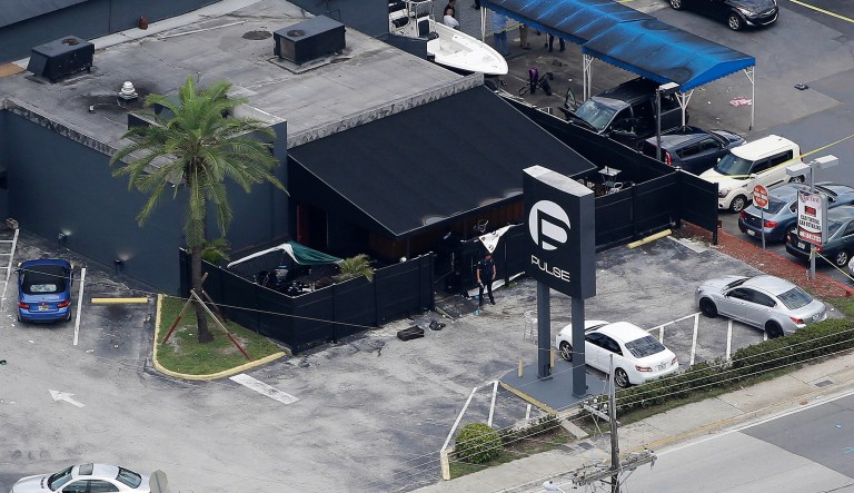 FILE - In this June 12, 2016 file photo, law enforcement officials work at the Pulse nightclub in Orlando, Fla., following a mass shooting. The widow of the gunman who killed dozens of people at the Pulse nightclub in Orlando is going on trial Wednesday, March 14, 2018, in federal court. Thirty-one-year-old Noor Salman is charged with aiding and abetting her deceased husband Omar Mateen in planning the 2016 attack on the Pulse nightclub.