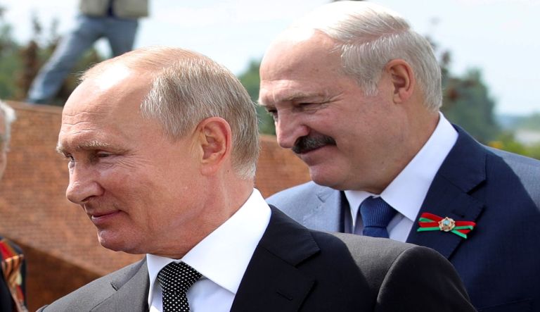 In this file photo taken on Tuesday, June 30, 2020, Russian President Vladimir Putin, left, and Belarusian President Alexander Lukashenko greet WWII veterans during an opening ceremony of the monument in honour of the World War II Red Army, in the village of Khoroshevo, just outside Rzhev, about 200 kilometers (about 125 miles) northwest of Moscow, Russia. President Alexander Lukashenko is seeking a sixth term in the Aug. 9 election but he has accused Russian forces of interfering with the upcoming vote, although Moscow has denied any involvement.
