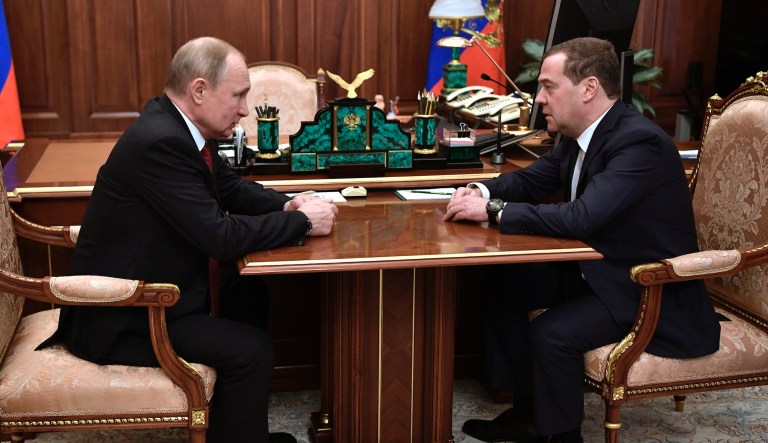 Russian President Vladimir Putin, left, listens to  Russian Prime Minister Dmitry Medvedev during their meeting in the Kremlin in Moscow, Russia, Wednesday, Jan. 15, 2020.                                 