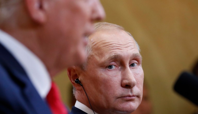 Russian President Vladimir Putin listens to U.S. President Donald Trump during a press conference after the meeting of U.S. President Donald Trump and Russian President Vladimir Putin at the Presidential Palace in Helsinki, Finland, Monday, July 16, 2018.