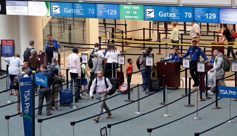 Air passengers heading to their departure gates enter TSA precheck before going through security screening at Orlando International Airport Thursday, June 21, 2018, in Orlando, Fla.