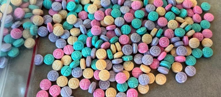The image shows fentanyl pills in multiple colors, which the DEA says is an intentional move by the drug cartels to make them 