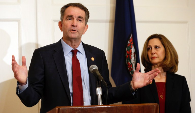 Virginia Gov. Ralph Northam, left, gestures as his wife, Pam, listens during a press conference in the Governors Mansion at the Capitol in Richmond, Va., Saturday, Feb. 2, 2019.