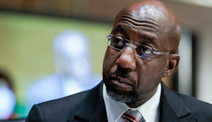 Sen. Raphael Warnock (D-GA) listens to Dr. Philip Nathan Jefferson, of North Carolina, nominated to be a member of the Board of Governors of the Federal Reserve System, during a Senate Banking, Housing, and Urban Affairs Committee confirmation hearing on Capitol Hill in Washington, D.C., Feb. 3, 2022.  