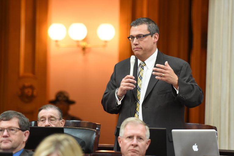 Ohio State Representative Ron Hood, a Republican, stands up and speaks during a legislative session.