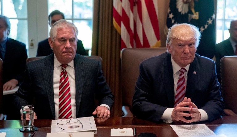 President Donald Trump, accompanied by Secretary of State Rex Tillerson, participates in a Cabinet meeting at the White House.