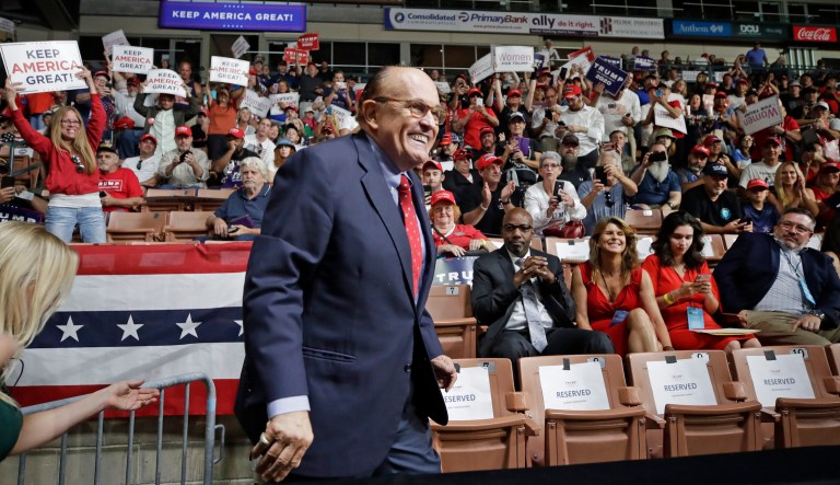 Former New York City Mayor Rudy Giuliani smiles as he arrives to President Donald Trump's campaign rally, Thursday, Aug. 15, 2019, in Manchester, N.H.
