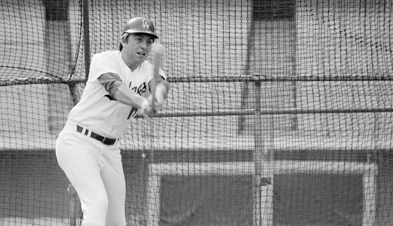 Outfielder Rick Monday of the Los Angeles Dodgers watches the flight of the ball as it leaves the bat during practice at Dodger Stadium in Los Angeles, Calif., Jan. 20, 1977. Monday was traded to the Dodgers in the off-season by the Chicago Cubs. Monday was the outfielder that took the U.S. flag away from two people attempting to burn it on April 25, 1976.
