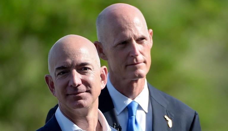 Amazon CEO Jeff Bezos, left, and Florida Gov. Rick Scott arrive for a news conference unveiling the new Blue Origin rocket at the Cape Canaveral Air Force Station in Cape Canaveral, Fla., Tuesday, Sept. 15, 2015.