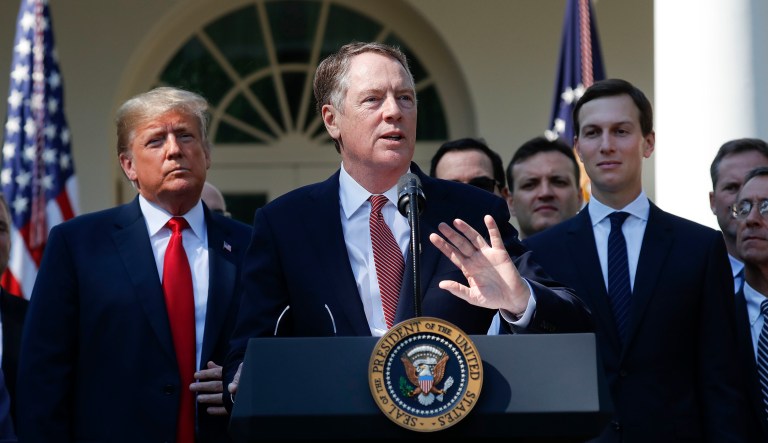 U.S. Trade Representative Ambassador Robert Lighthizer, center, gestures while speaking after President Donald Trump, left, announced a revamped North American free trade deal, in the Rose Garden of the White House in Washington, Monday, Oct. 1, 2018. Also on stage is White House Senior Adviser Jared Kushner, right. The new deal, reached just before a midnight deadline imposed by the U.S., will be called the United States-Mexico-Canada Agreement, or USMCA. It replaces the 24-year-old North American Free Trade Agreement, which President Donald Trump had called a job-killing disaster.