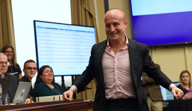 Rep.-elect Max Rose, D-N.Y., stretches his arms as he walks up to pick his number during the Member-elect room lottery draw on Capitol Hill in Washington, Friday, Nov. 30, 2018.
