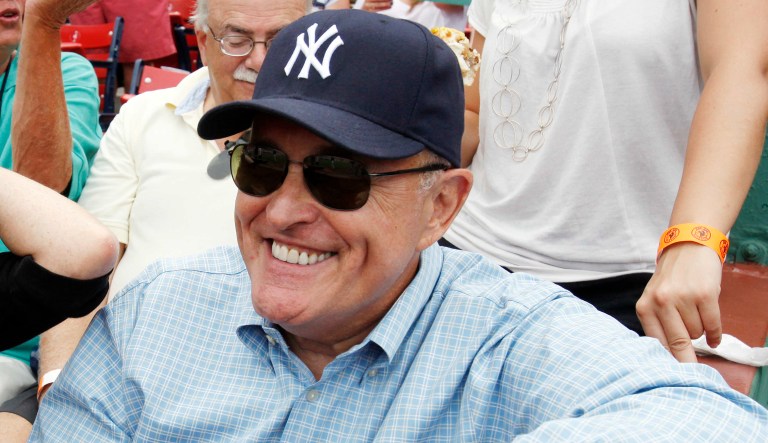 Former New York Mayor Rudy Giuliani, right, and his wife, Judith Nathan Giuliani, sit in the stands before a baseball game between the Boston Red Sox and the New York Yankees in Boston, Saturday, Aug. 6, 2011.