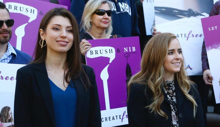 This Jan. 22, 2019 file photo shows Christian artists Joanna Duka, front left, and Breanna Koski, front right, outside the Arizona Supreme Court after justices heard arguments over Phoenix's anti-discrimination ordinance that bars businesses from refusing service to same-sex couples for religion reasons. Duka and Koski, who operate a business that makes invitations and other wedding-related items, had challenged the constitutionality of the ordinance. 