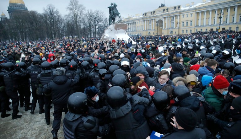 People clash with police during a protest against the jailing of opposition leader Alexei Navalny in St.Petersburg, Russia, Saturday, Jan. 23, 2021. Russian police on Saturday arrested hundreds of protesters who took to the streets in temperatures as low as minus-50 C (minus-58 F) to demand the release of Alexei Navalny, the country's top opposition figure. A Navalny, President Vladimir Putin's most prominent foe, was arrested on Jan. 17 when he returned to Moscow from Germany, where he had spent five months recovering from a severe nerve-agent poisoning that he blames on the Kremlin.