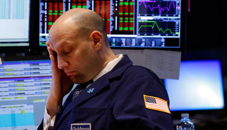 In this Wednesday, March 19, 2014, file photo, Specialist Meric Greenbaum works at his post on the floor of the New York Stock Exchange. 2014. U.S. stocks are falling in midday trading Monday, March 24, 2014, as tensions with Russia escalate.