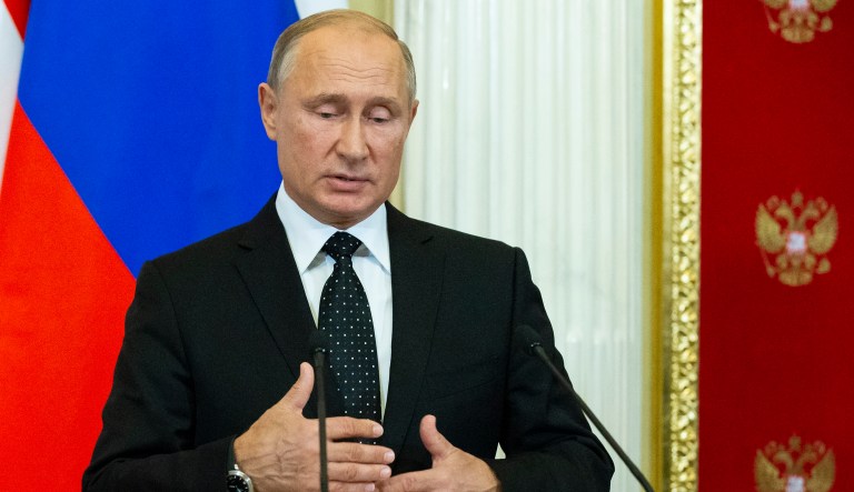 Russian President Vladimir Putin gestures while speaking to the media during a joint news conference with Hungarian Prime Minister Viktor Orban after their talks in the Kremlin in Moscow, Russia, Tuesday, Sept. 18, 2018. Putin says "a chain of tragic circumstances" is to be blamed for a Russian military aircraft shot down by a Syrian missile. He vowed to boost security for Russian troops there.