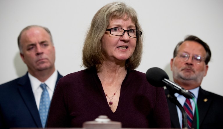 Elizabeth Whelan, the sister of Paul Whelan, accompanied by Sen. Gary Peters., D-Mich., right, and Rep. Dan Kildee, D-Mich., left, speaks at a news conference on Capitol Hill in Washington, Thursday, Sept. 12, 2019, to call on Congress to pass a resolution condemning the Russian government for detaining Paul Whelan. 