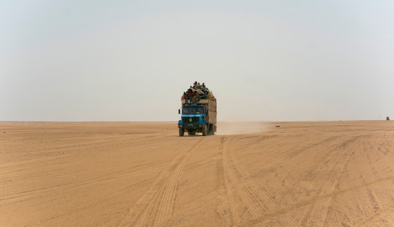 A truck carrying goods and migrants drives through Niger's Tenere desert region of the south central Sahara on Sunday, June 3, 2018. 