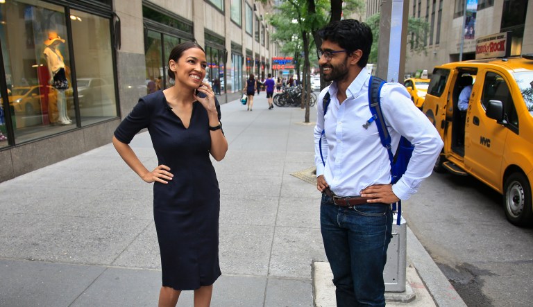 Alexandria Ocasio-Cortez, left, the winner of the Democratic primary in New York's 14th Congressional District, speaks on a phone as Saikat Chakrabarti, her senior campaign adviser stands by, Wednesday, June 27, 2018, in New York.