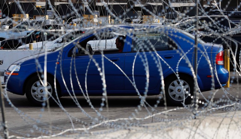 A driver waits in line behind newly placed barbed wire, before crossing the Mexico-U.S. border, in Tijuana, Mexico, Monday, Nov. 19, 2018. The United States closed off northbound traffic for several hours at the busiest border crossing with Mexico to install new security barriers on Monday, a day after hundreds of Tijuana residents protested against the presence of thousands of Central American migrants.