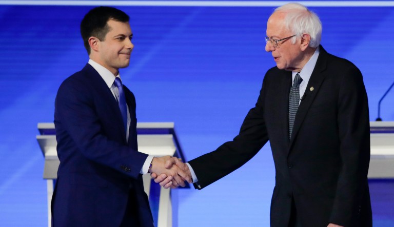 From left, Democratic presidential candidates entrepreneur Andrew Yang, former South Bend Mayor Pete Buttigieg, Sen. Bernie Sanders, I-Vt., former Vice President Joe Biden, Sen. Elizabeth Warren, D-Mass., Sen. Amy Klobuchar, D-Minn., and businessman Tom Steyer stand on stage Friday, Feb. 7, 2020, before the start of a Democratic presidential primary debate hosted by ABC News, Apple News, and WMUR-TV at Saint Anselm College in Manchester, N.H.