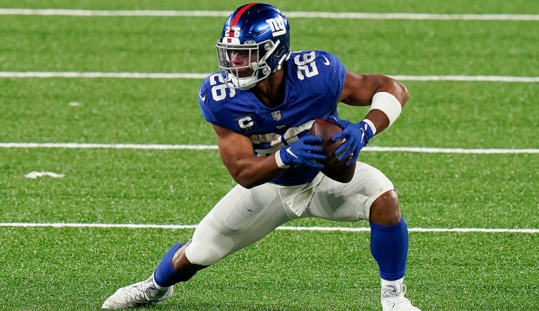 In this Sept. 14, 2020, file photo, New York Giants running back Saquon Barkley carries the ball during the third quarter against the Pittsburgh Steelers in an NFL football game in East Rutherford, N.J. The Giants picked up the fifth-year option on the rookie contract for Barkley. The 2018 Offensive Rookie of the Year is recovering from a torn right ACL in Week 2 of last season.