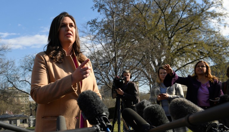 White House press secretary Sarah Sanders speaks to reporters outside the West Wing of the White House in Washington, Monday, March 25, 2019.