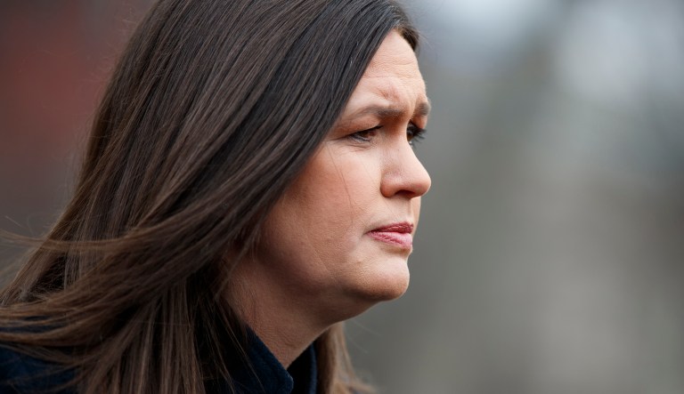 White House press secretary Sarah Huckabee Sanders listens to a question while speaking with reporters outside the White House, Wednesday, Jan. 23, 2019, in Washington.