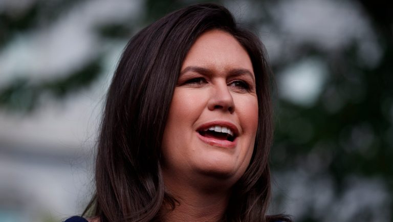 White House press secretary Sarah Sanders talks with reporters outside the White House, Wednesday, May 22, 2019, in Washington. 