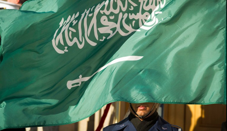 FILE - In this March 22, 2018 file photo, an Honor Guard member is covered by the flag of Saudi Arabia as Defense Secretary Jim Mattis welcomes Saudi Crown Prince Mohammed bin Salman to the Pentagon with an Honor Cordon, in Washington Saudi Arabiaâs Interior Ministry said Tuesday, April 23, 2019, that 37 Saudi citizens have been beheaded in a mass execution that took place across various regions of the country. Saudi King Salman ratified the executions for terrorism-related crimes by royal decree. 