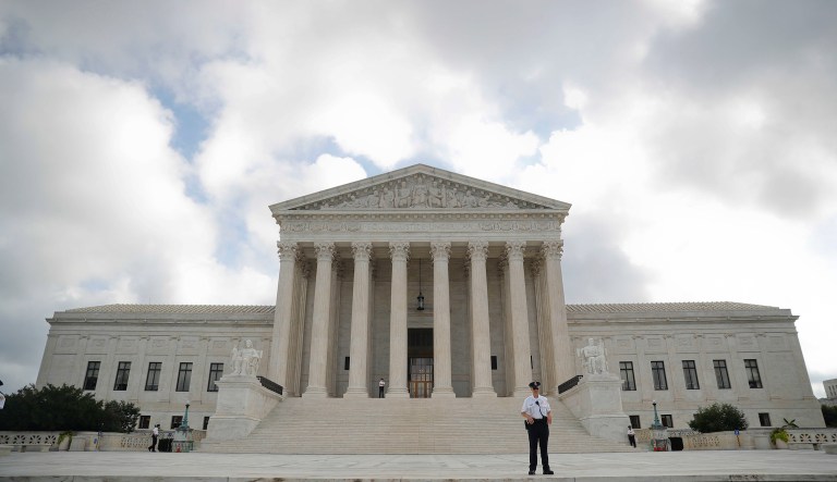 Police office guards the main entrance to the Supreme Court in Washington, Tuesday, Oct. 9, 2018. A Supreme Court with a new conservative majority takes the bench as Brett Kavanaugh, narrowly confirmed after a bitter Senate battle, joins his new colleagues to hear his first arguments as a justice.